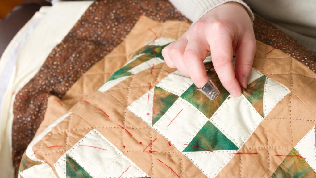 Detailed illustration showing the process of hanging a wall quilt securely, featuring tools and techniques.