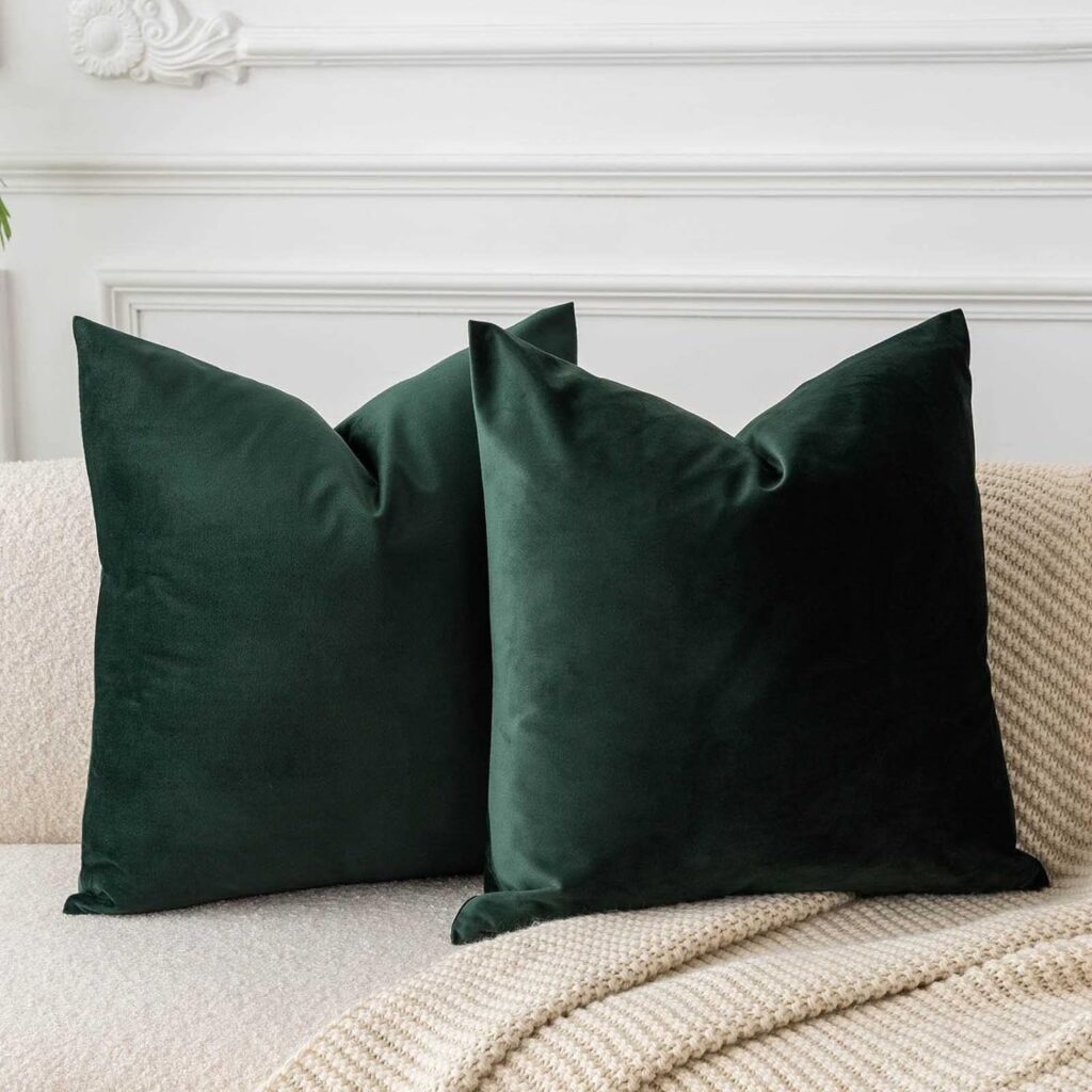 Vibrant emerald green pillow covers on a couch, revitalizing the room's decor