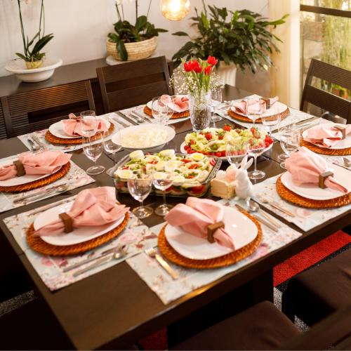 An elegantly decorated Easter dining table, complete with pastel linens, Easter flowers, and themed centerpieces, embodying the joy of spring.