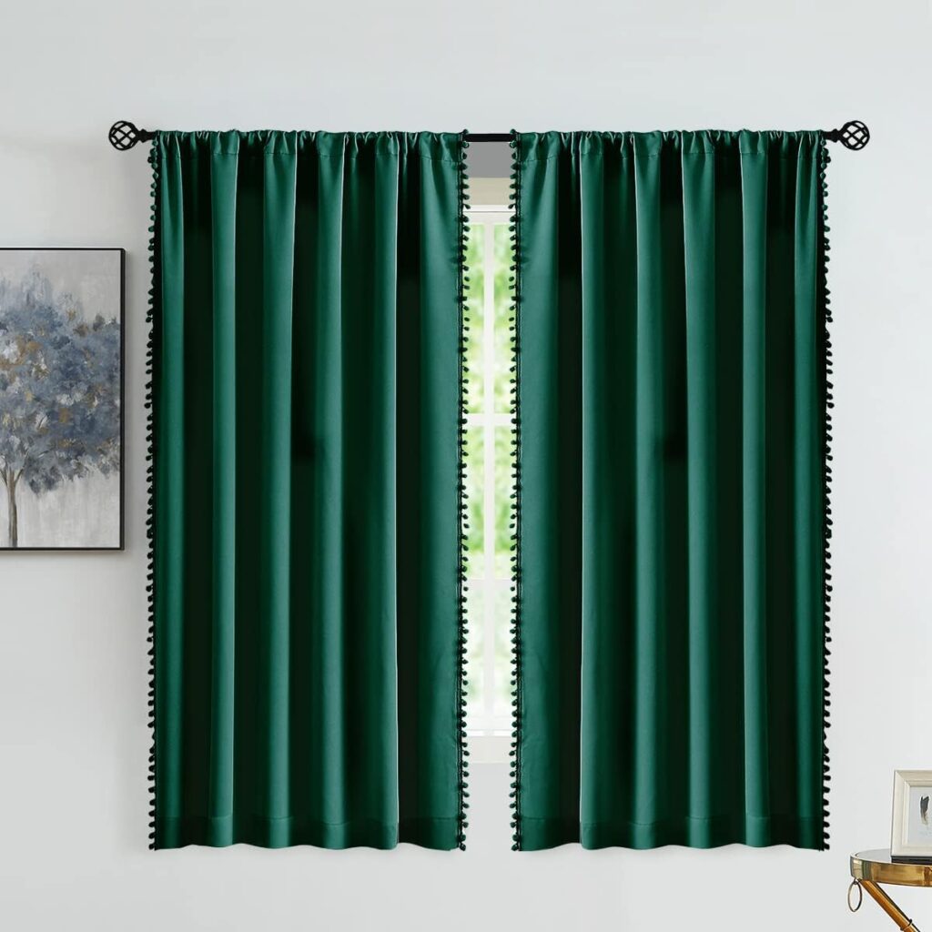 Emerald green curtains framing a window, blending indoor space with outdoor nature.