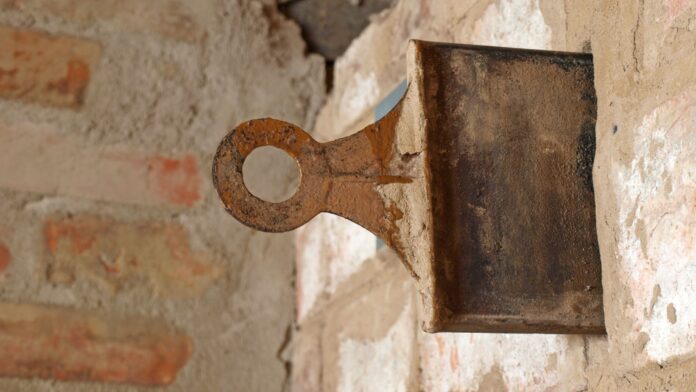 Dampers in Fireplace - A close-up shot of an age-old cast iron throat damper, perfectly positioned above the firebox, showcasing the traditional method for managing air intake and smoke exhaust in residential fireplaces.