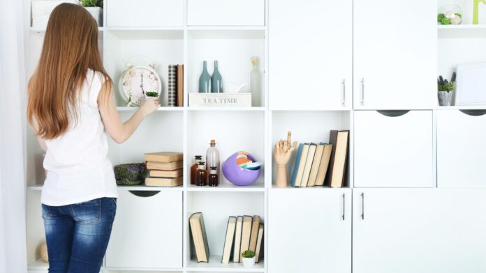 A neatly organized living room with labeled storage boxes, clear countertops, and a sparkling clean surface, embodying the essence of efficient home organizing and cleaning.