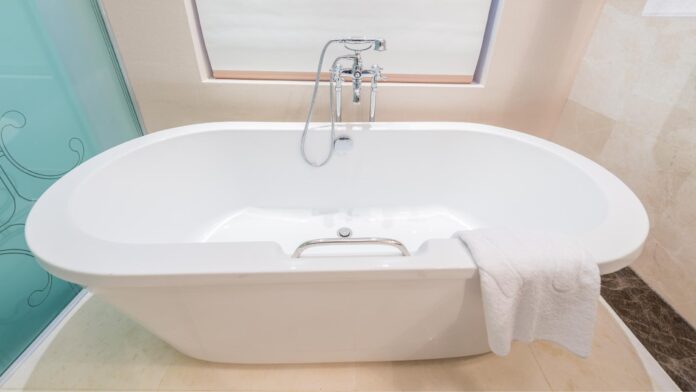 Sparkling clean jet bathtub in a brightly lit bathroom, showcasing hygiene and luxury.